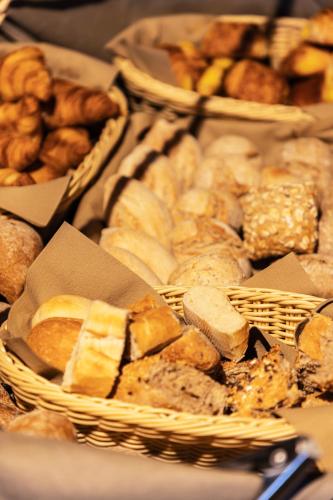 a bunch of different types of bread and pastries at Hotel Ter Brughe by CW Hotel Collection in Bruges