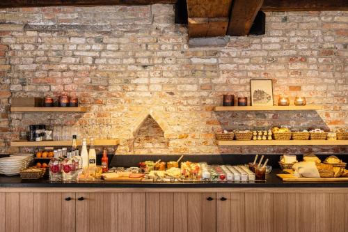 a kitchen with a buffet of food on a counter at Hotel Ter Brughe by CW Hotel Collection in Bruges