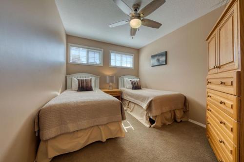 a bedroom with two beds and a ceiling fan at Marble Canyon in Fairmont Hot Springs