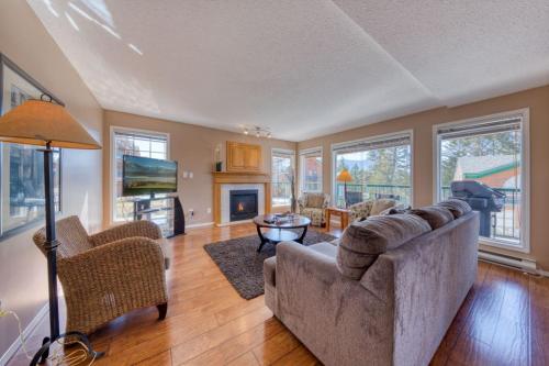 a living room with a couch and a fireplace at Marble Canyon in Fairmont Hot Springs