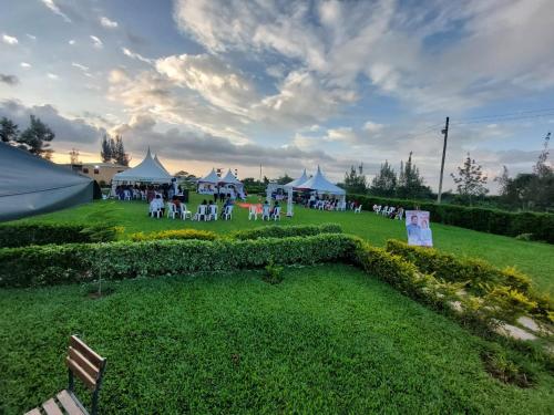 a group of tents in a park with a group of people at Koma Gardens and Resort in Nguluni