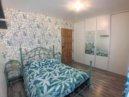 1 dormitorio con 1 cama con colcha azul y blanca en Villa avec piscine, en Saint-Gilles