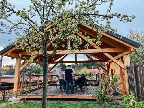a group of people standing on a wooden deck at Chalupa Lodge in Varvažov