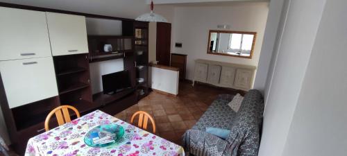 a living room with a table and a dining room at Residenza Gaia in Ispra