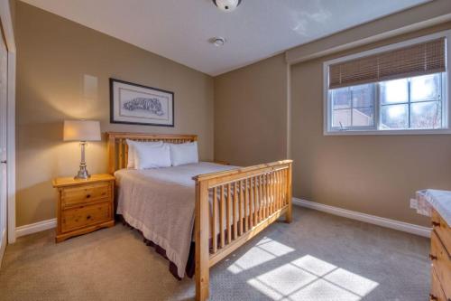 a bedroom with a crib and a window at Marble Canyon in Fairmont Hot Springs