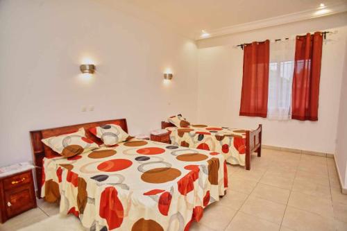 a bedroom with two beds in a room at Sara Chambre d'hôtes in Antananarivo