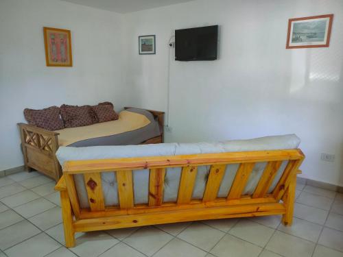 a bedroom with two beds and a tv on the wall at Departamento San Luis 320 in General Roca