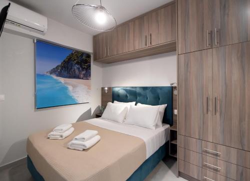 a bedroom with a large bed with wooden cabinets at Katerina Luxurious Sea View in Nikiana
