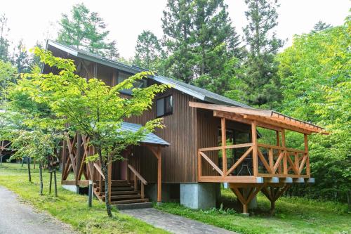 a wooden house with a gambrel roof at Farm Inn Neba - Vacation STAY 46696v in Urugi