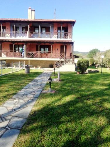 a large red building with a walkway in front of it at Villa near Ierissos in Ierissos