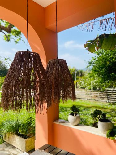 two wicker potted plants sitting on a window sill at KIPOS-SS residences in Dassia