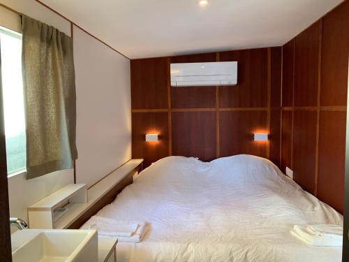 a bedroom with a large white bed and a sink at Péniche Anna Maria 4 in Sète