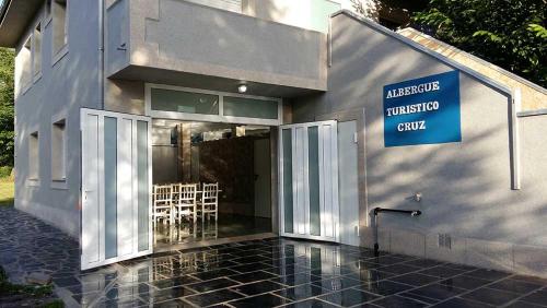 a building with a sign on the side of it at Cruz de Ferreira in Palas de Rei