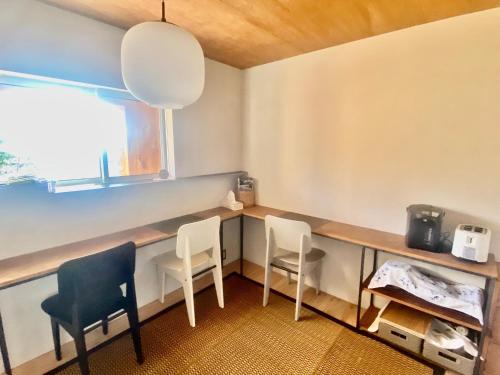 a room with two chairs and a desk and a window at Togaku Hokosha - Vacation STAY 15781 in Nagano