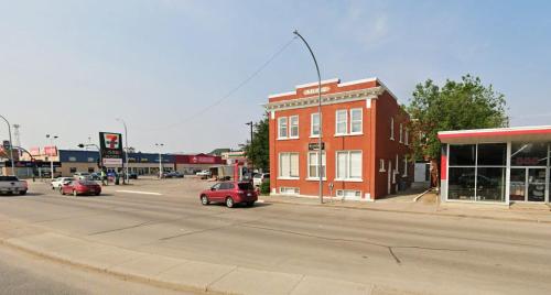 a city street with cars driving down a street at Large 1-bedroom Condo l Downtown l WiFi & Smart TV in Moose Jaw