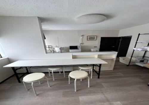 a kitchen with a table and two chairs and a counter at Ota Apartment - Vacation STAY 16060 in Otaru