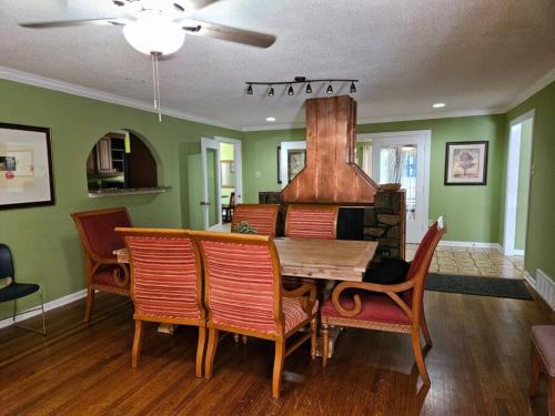 a dining room with a table and chairs and a fireplace at 6BR in Suburban area close to Freeway and Galeria in Memphis