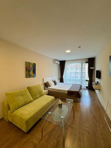 a living room with a couch and a bed at Premier Fort Apartment on Seafront in Sveti Vlas