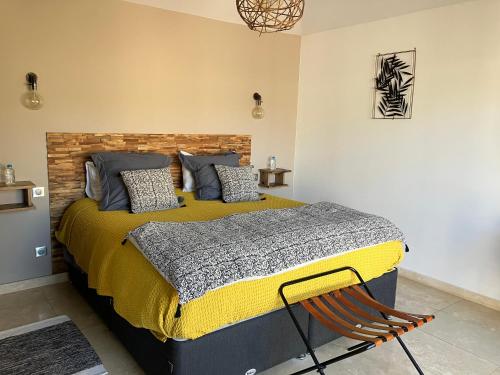a bedroom with a bed with a yellow and gray blanket at A Camerina in Sotta