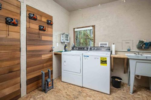 a kitchen with a washing machine and a sink at Cedar Camp in Welches
