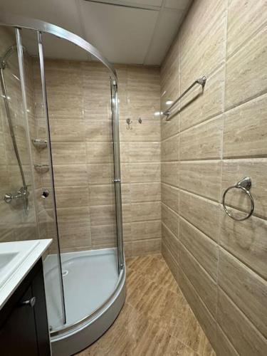 a bathroom with a shower and a sink at Premier Fort Apartment on Seafront in Sveti Vlas