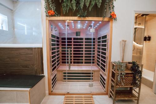 a walk in shower in a room with a glass door at Edera Spa in Rueil-Malmaison