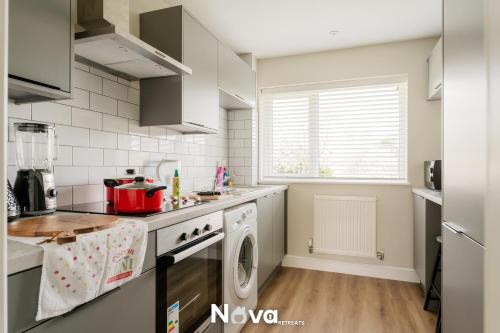 a kitchen with a washer and a dishwasher at Luxury 3 Bed Apartment, Private Parking BHX JLR NEC HS2 in Solihull