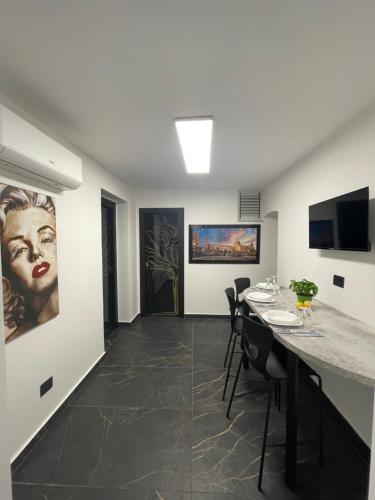 a room with a table with chairs and a painting on the wall at Casa Vacanze Donna Sidora in Palermo