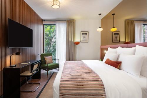 a hotel room with a large bed and a desk at Artizan - Design Hotel in Tbilisi City