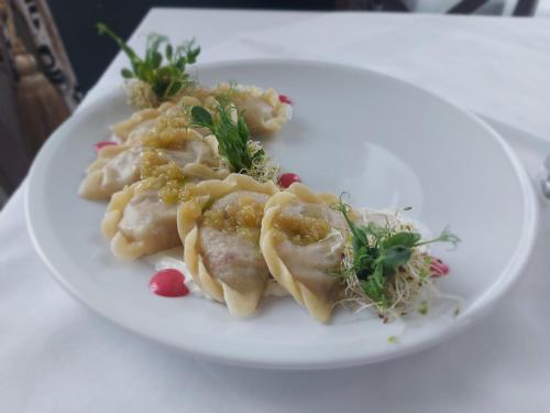 a plate of food with pasta on a table at Impresja Restauracja Hotel in Zambrów
