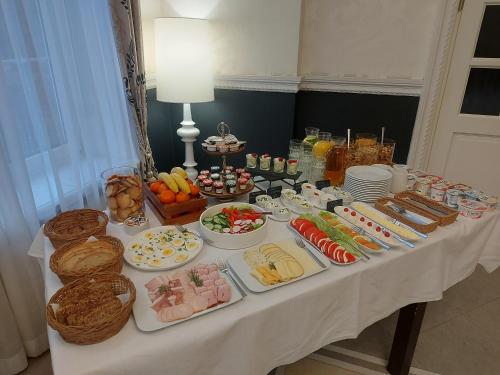 a table with a buffet of food on it at Impresja Restauracja Hotel in Zambrów