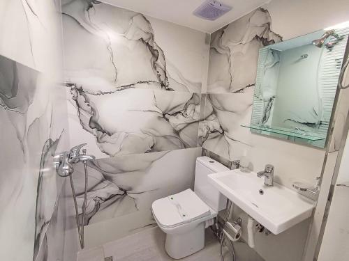 a bathroom with a toilet and a sink at Vila Guri i Atos in Përmet