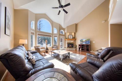 a living room with leather furniture and a fireplace at Marble Canyon in Fairmont Hot Springs