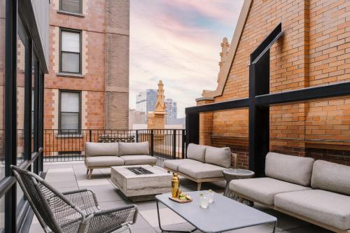 a balcony with couches and tables on a building at Sonder The Plymouth in Chicago