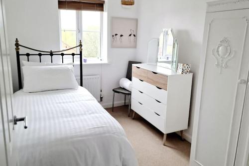a bedroom with a bed and a dresser with a mirror at Liam's place in Manchester