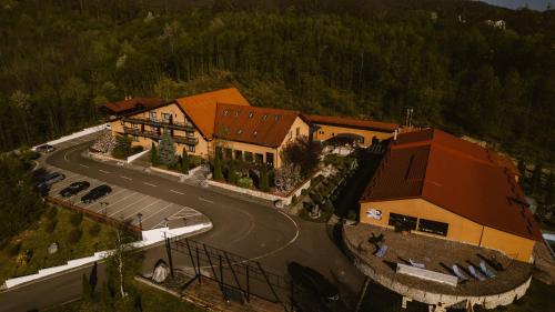 an aerial view of a large house with a road at Bellacya Resort & Spa in Sovata