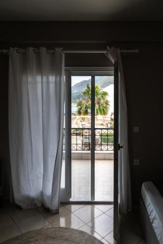 a sliding glass door with a view of a balcony at Blue Hug Apartments in Plataria
