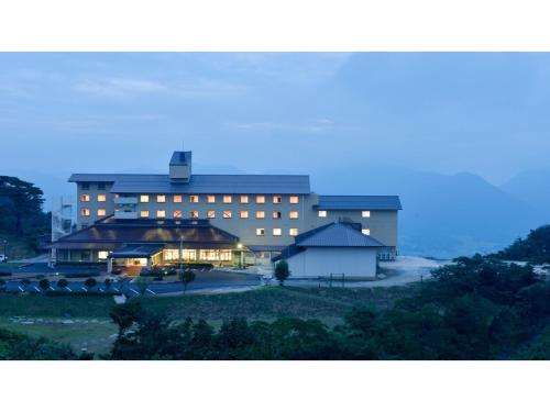 un grand bâtiment avec des lumières allumées devant lui dans l'établissement Ikoi no Mura Shimane - Vacation STAY 27447v, à Kyōmendao