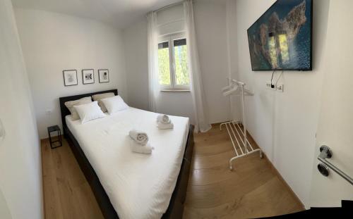 a bedroom with a bed with two towels on it at Apartment Marta in Orebić