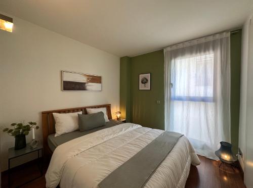 um quarto com uma cama grande e uma janela em Cozy Place Picasso em Barcelona