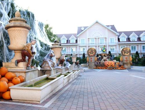 a water fountain in front of a building with pumpkins at Gardaland Hotel in Castelnuovo del Garda