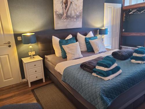 1 dormitorio con 2 camas y almohadas azules y blancas en Luna et Sol - Haus Am See Seeblick-Apartment en Seehausen