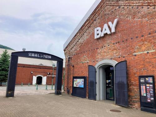 a brick building with a bay sign on it at Hotel Tetora Yunokawaonsen - Vacation STAY 30586v in Hakodate
