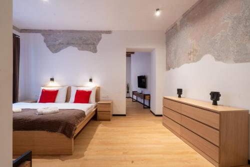 a bedroom with a large bed with red pillows at Hviezdoslavova Apartments, Trnava Centre, Parking available in Trnava