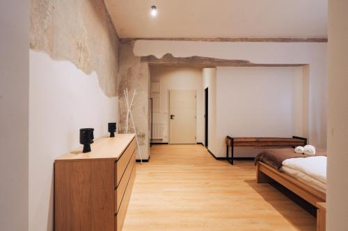 a bedroom with a bed and a wooden dresser at Hviezdoslavova Apartments, Trnava Centre, Parking available in Trnava
