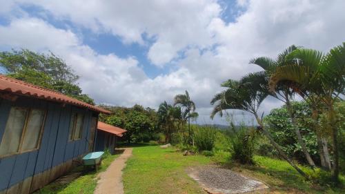 a blue house with a bench next to a yard at Garduk lodge in La Palma