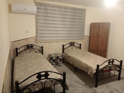 A bed or beds in a room at Bait al salam