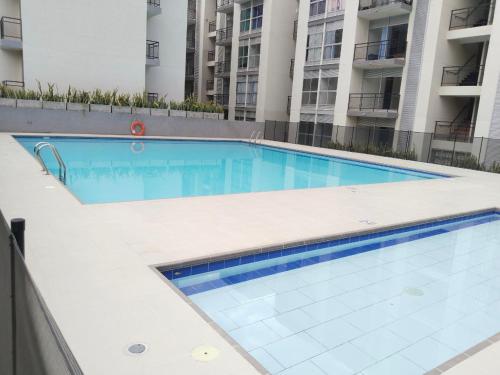 a swimming pool in the middle of a building at Hermoso apartamento en Melgar in Melgar
