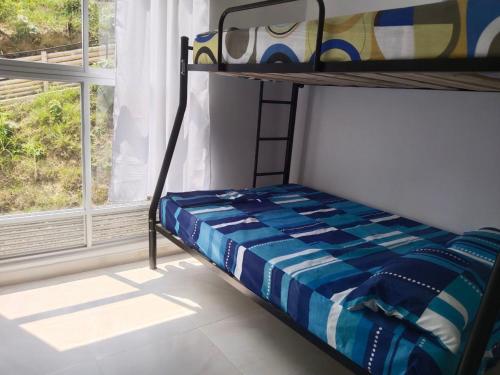 a bunk bed in a room with a window at Hermoso apartamento en Melgar in Melgar