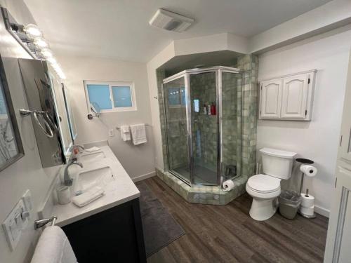 a bathroom with a shower and a toilet and a sink at Lakeview Ridge+ lake view + Balcony’s + Game Room in Lake Arrowhead